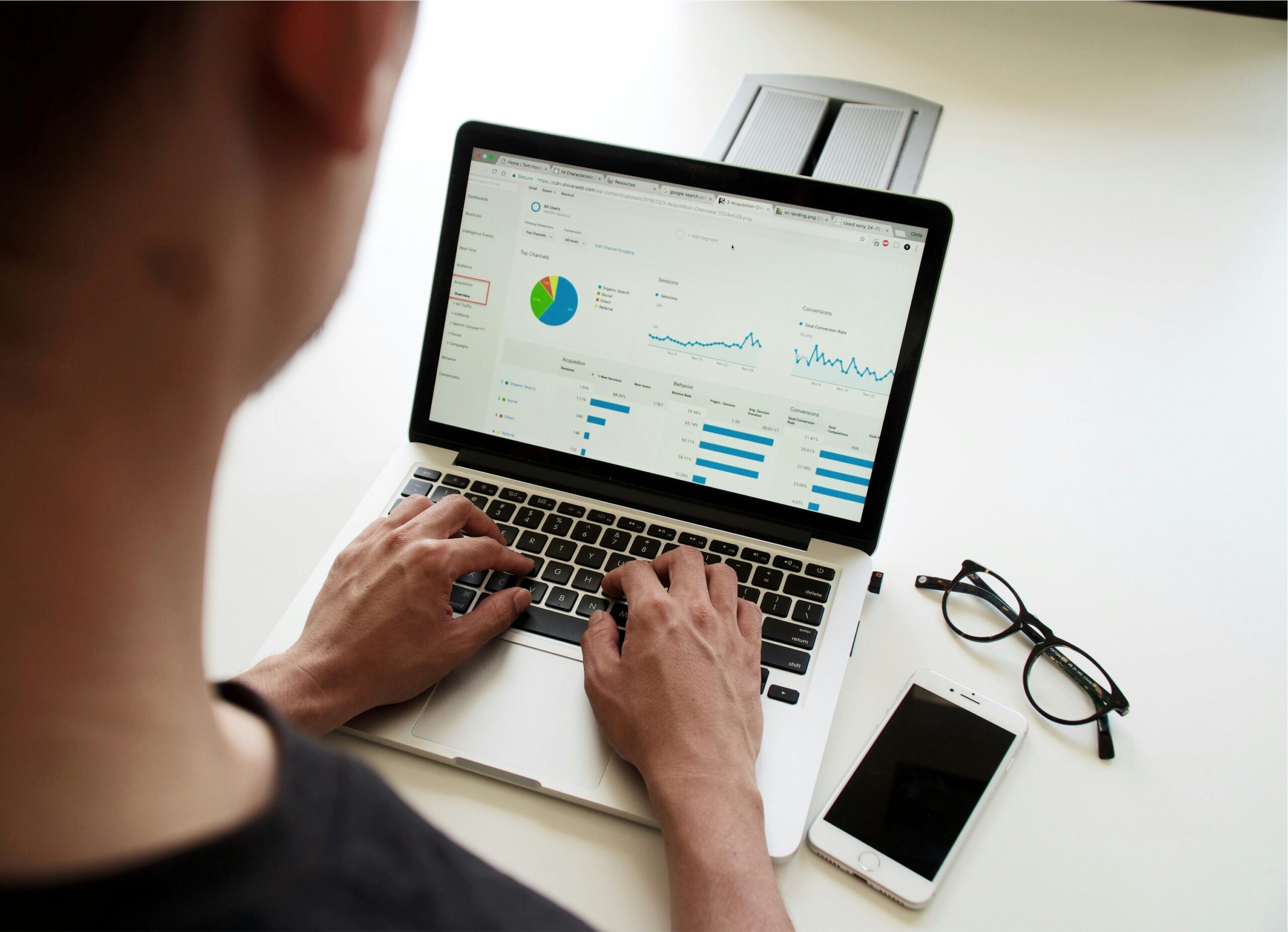 A person analyzing a financial report on their laptop